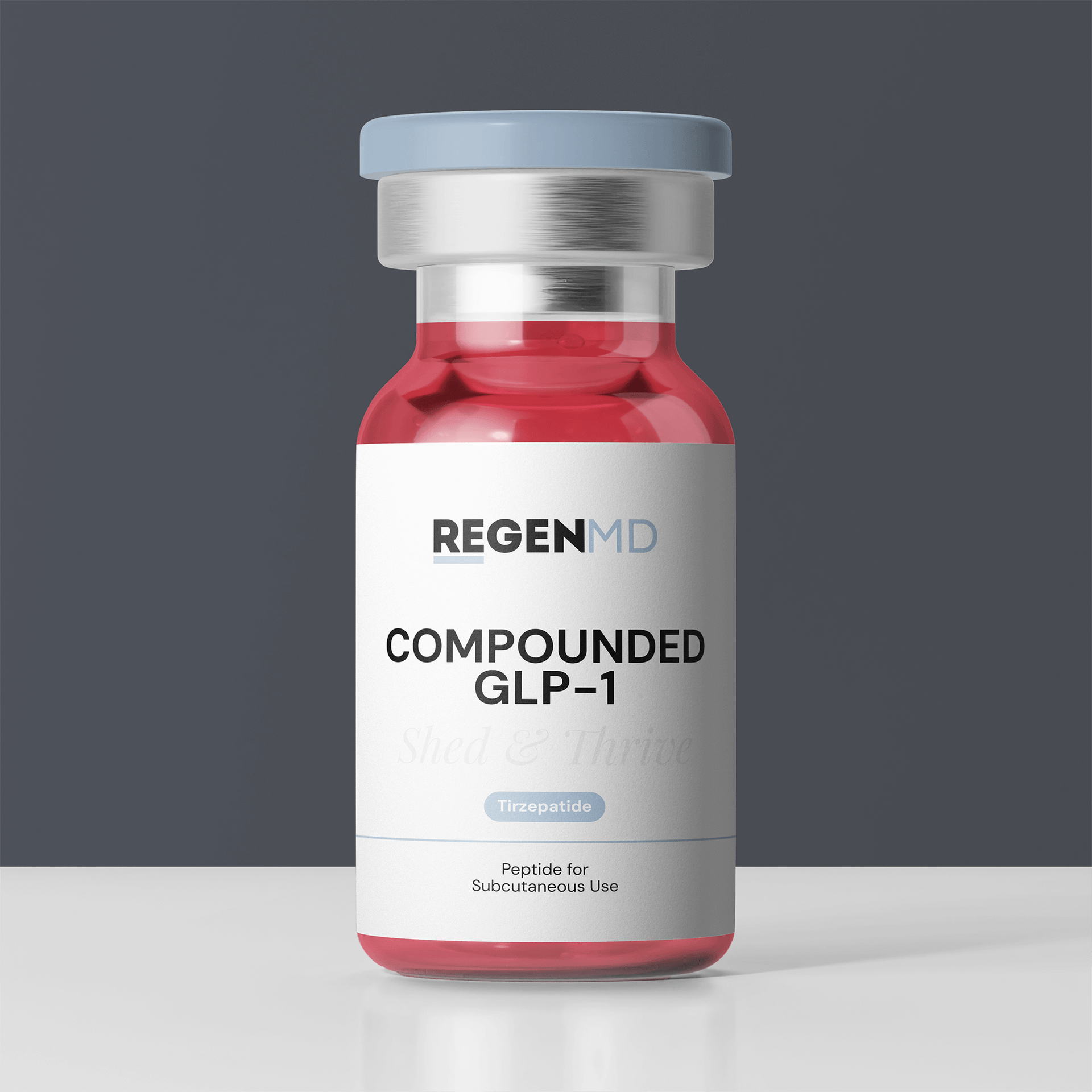 Tirzepatide, a compounded GLP-1, shown as a red liquid inside a peptide vial, with the bottle set in front of a dark grey background.