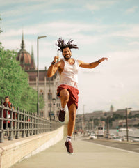 A man skips into the air demonstrating improved energy and exercise.